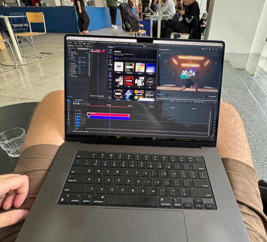 Editing a video on a laptop in an airport waiting area